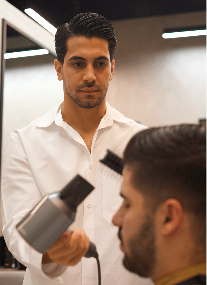 Stylist with blow-dryer at U Barbers
