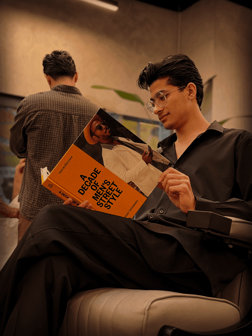 Client reading 'A Decade of Men's Street Style'